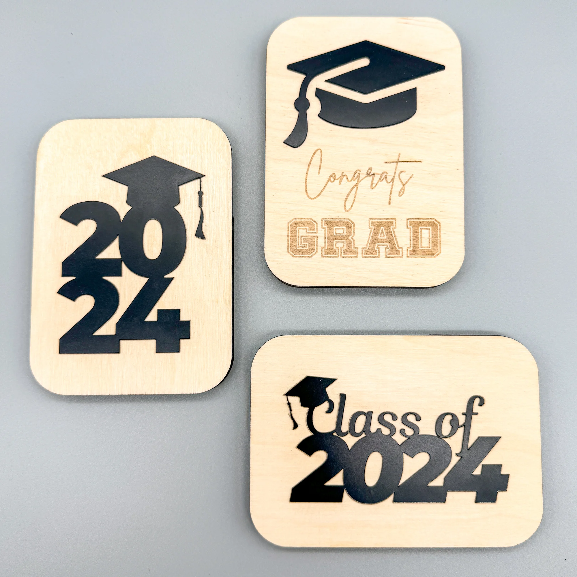 three variations of a laser cut DIY gift card holder for graduation