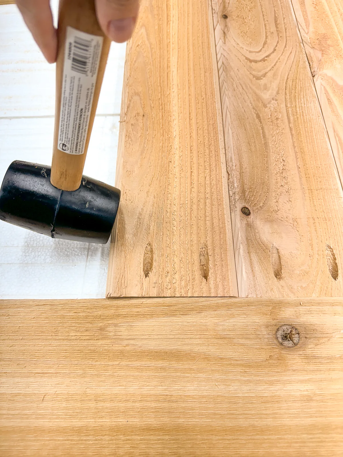 tapping tongue and groove boards together with a rubber mallet