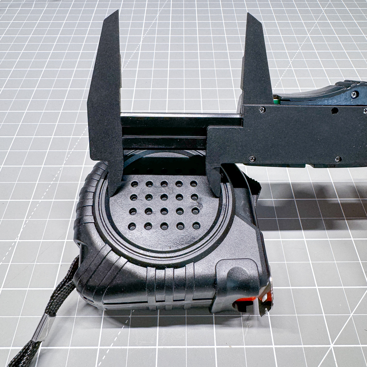 using calipers to measure the diameter of the insert circle on the tape measure casing