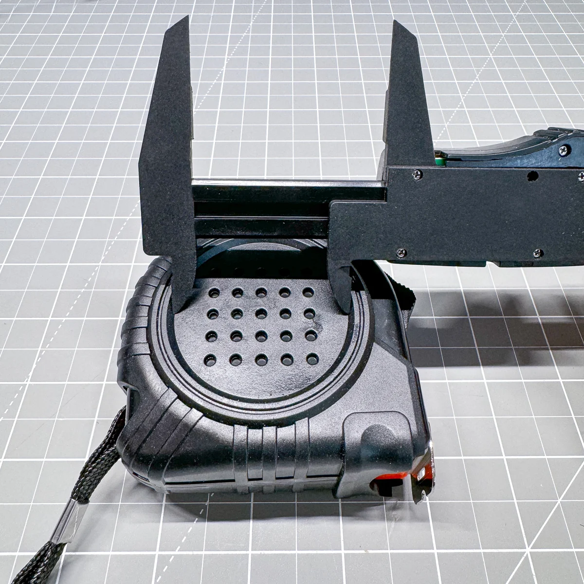 using calipers to measure the diameter of the insert circle on the tape measure casing