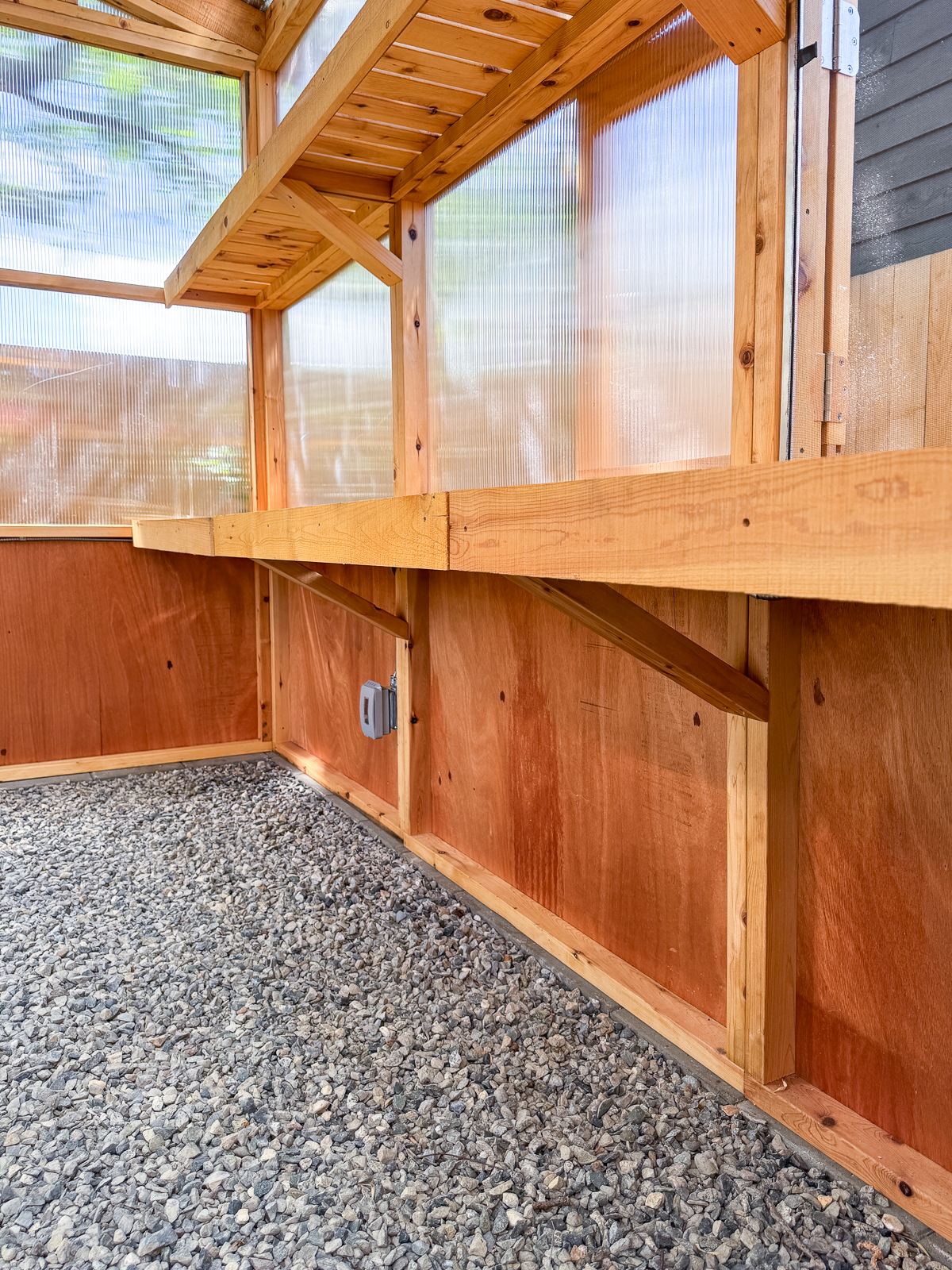 space under the greenhouse shelves where the cinder block shelves will be installed