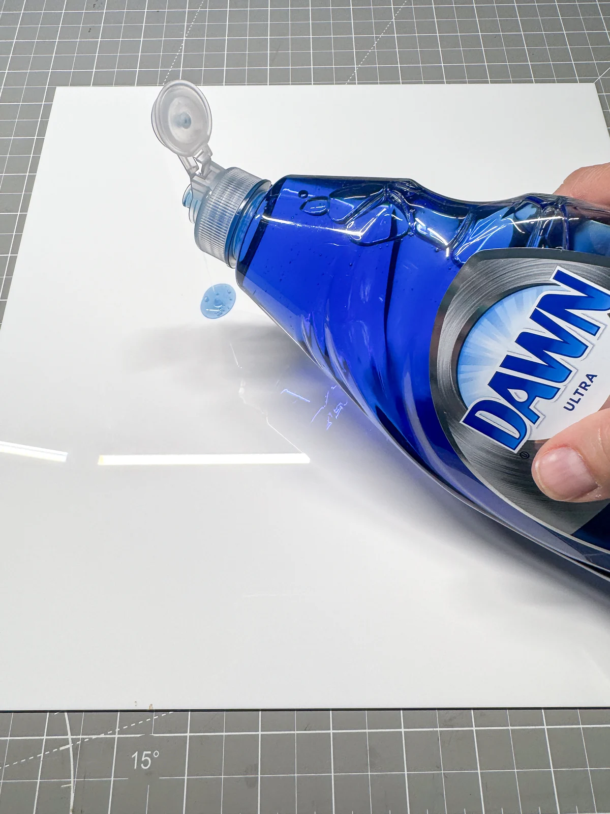 applying dish soap to acrylic before engraving