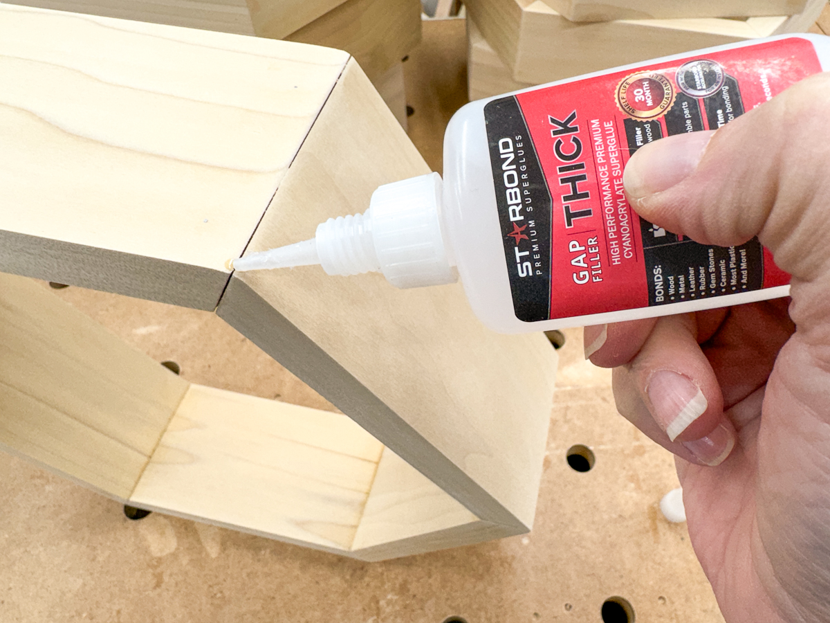 applying CA glue to open joints in hexagon shelf corners