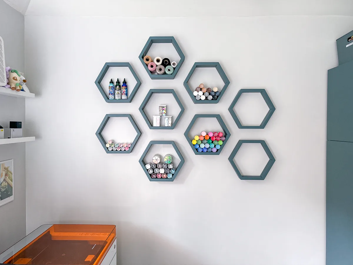 DIY hexagon floating shelves filled with craft supplies