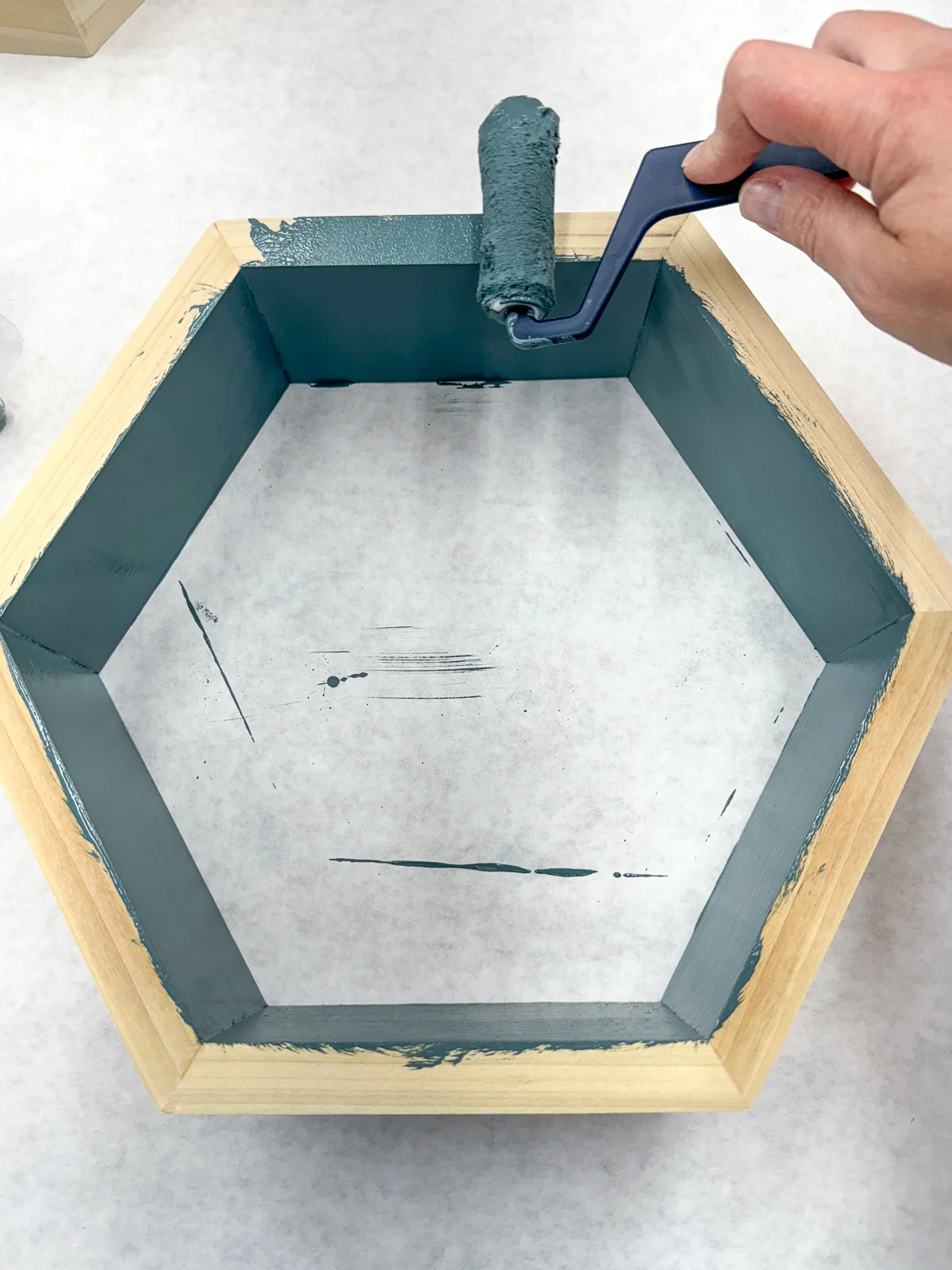 painting the front edge of the hexagon shelves with a small roller