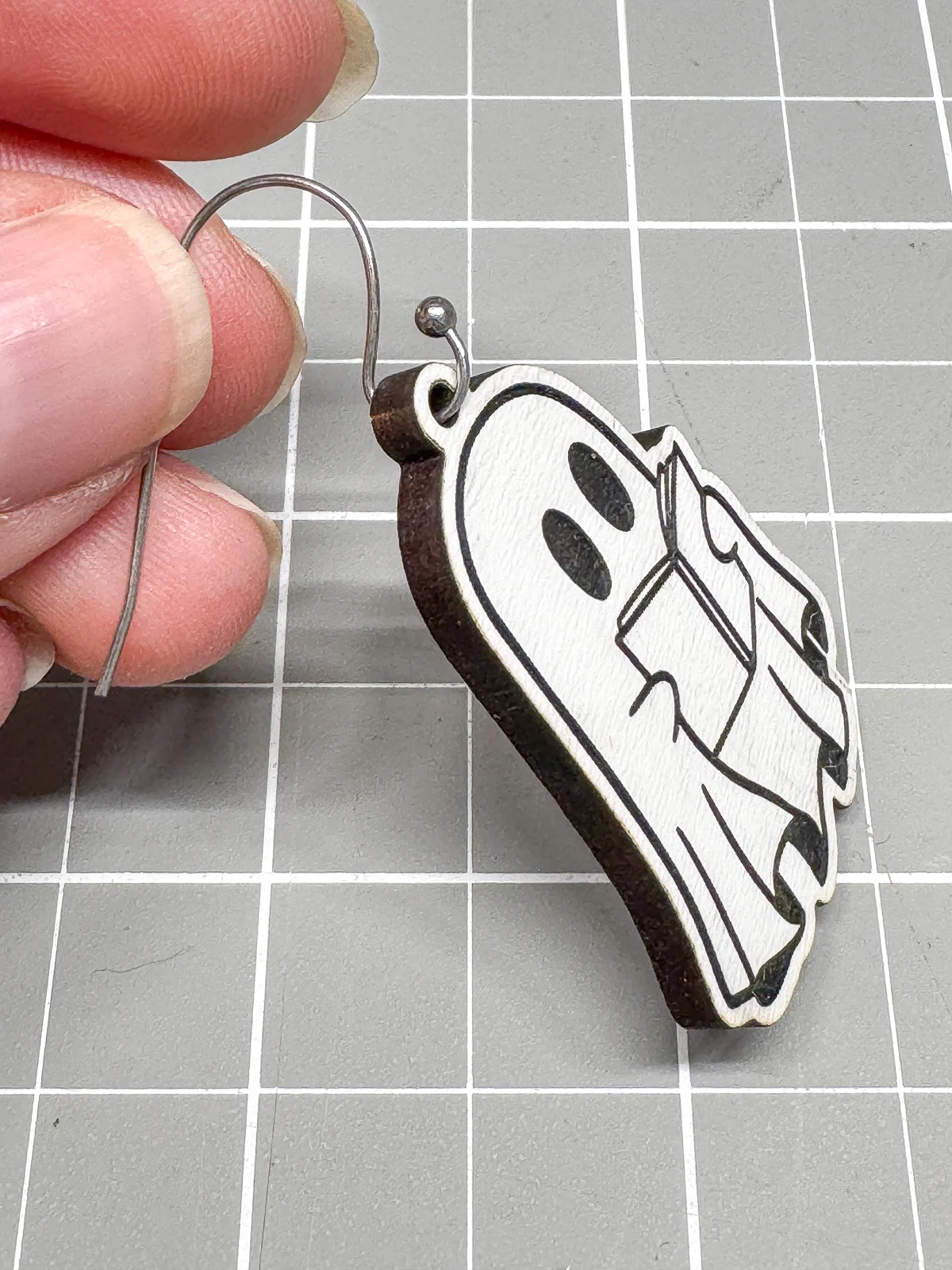 adding the earring hook to the ghost earrings