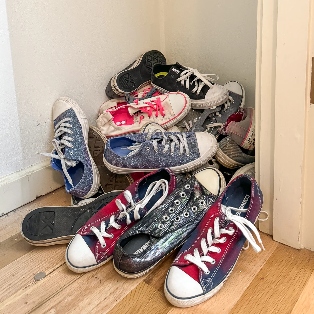 pile of shoes at the bottom of the closet