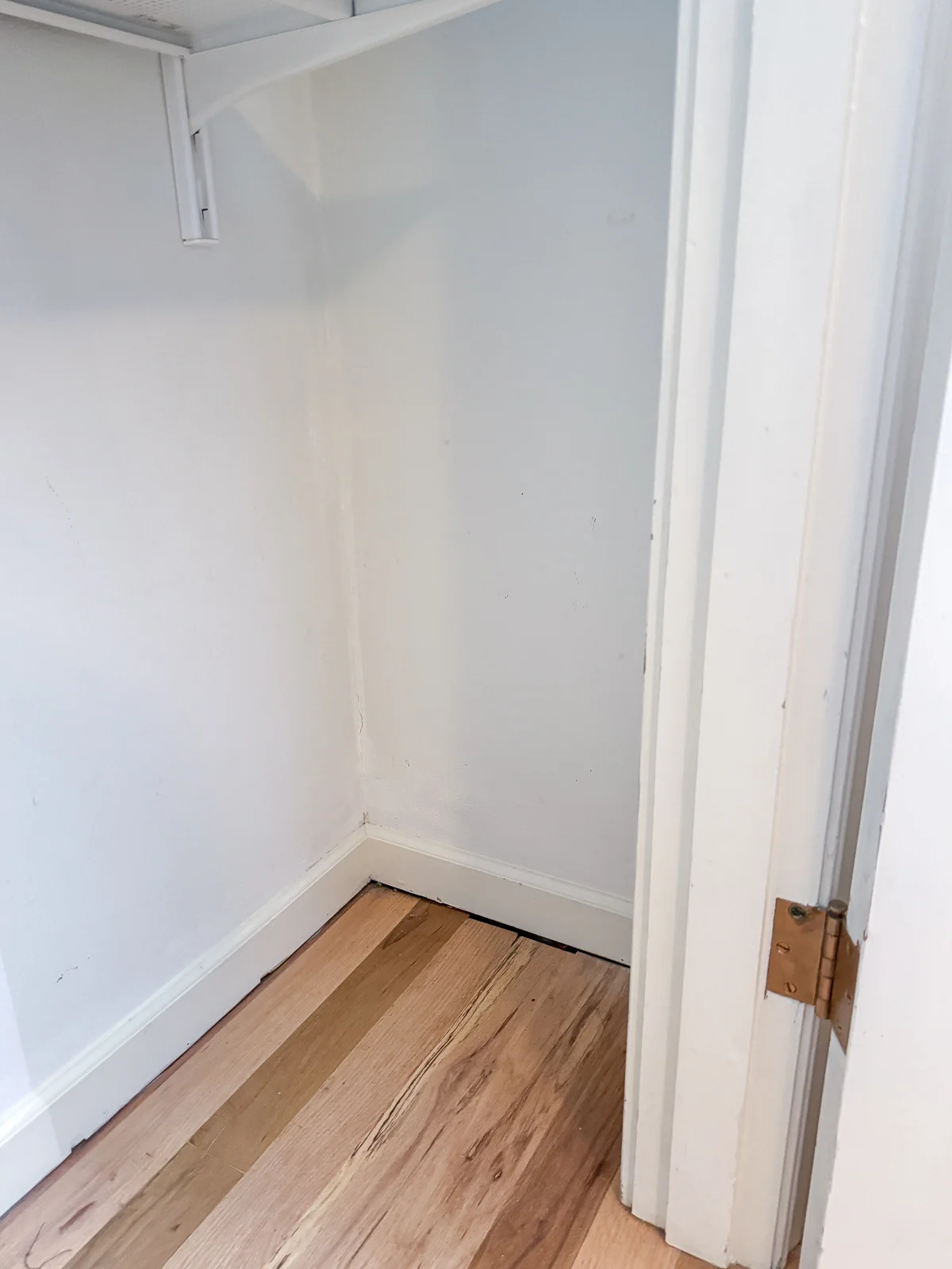 empty closet before installing shoe shelves