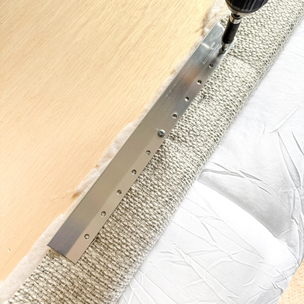 installing a French cleat on the back of a padded headboard