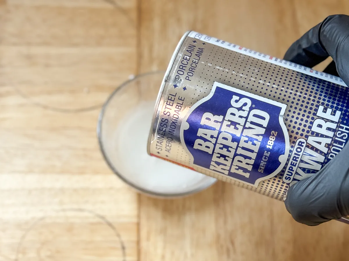 pouring barkeepers friend into a small bowl of water