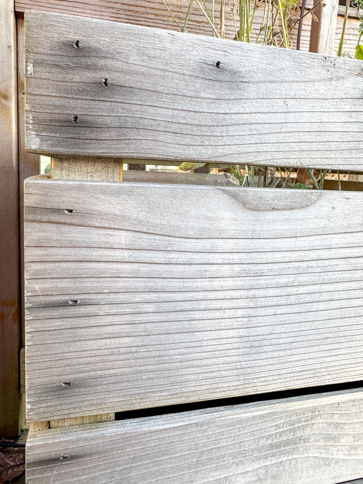 black rust stains from brad nails on wooden outdoor planter