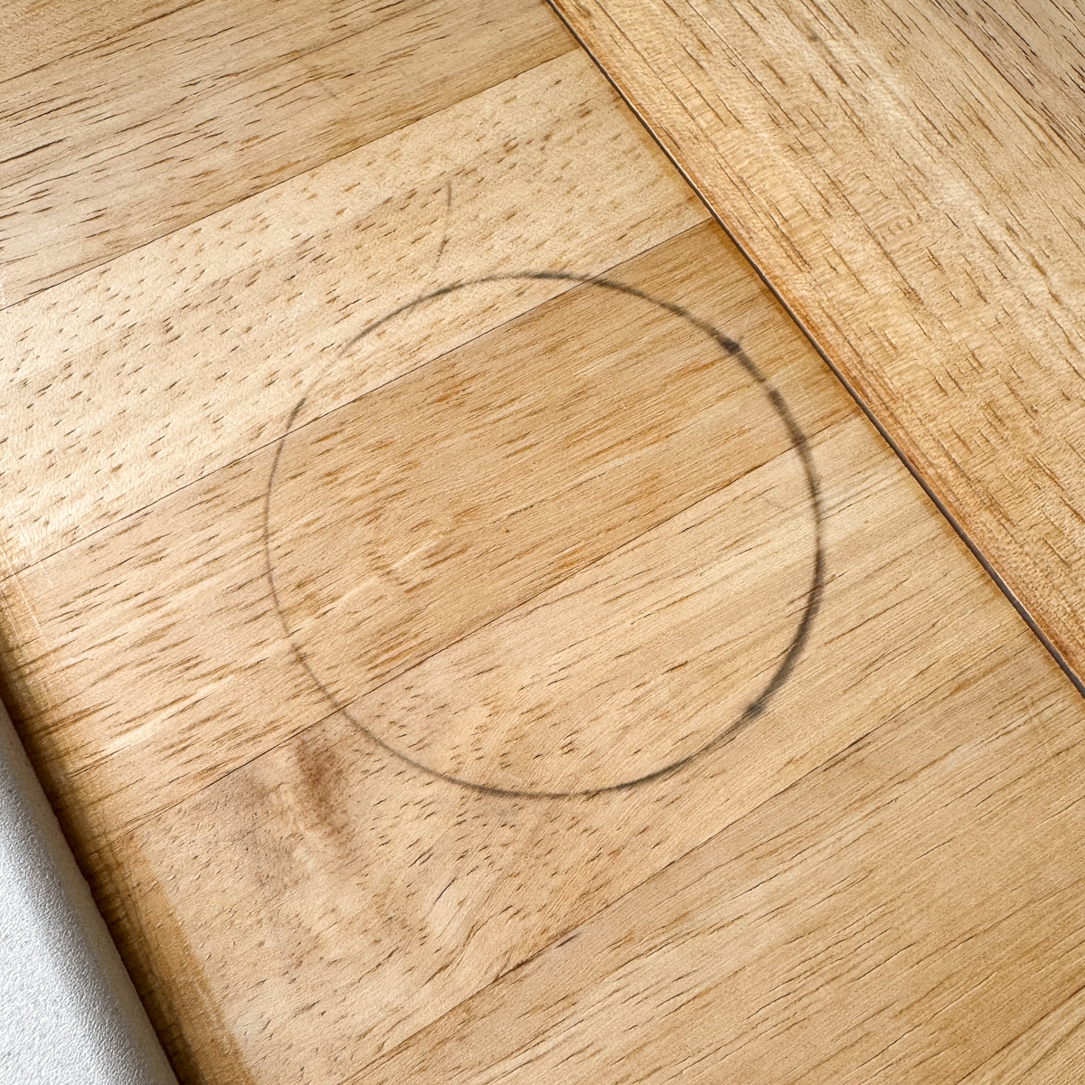 black ring on wood countertop from metal can