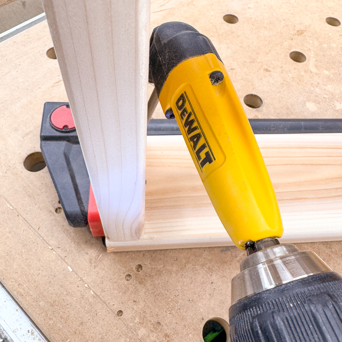 using a right angle drill attachment to get into the tight spot under the bottom step