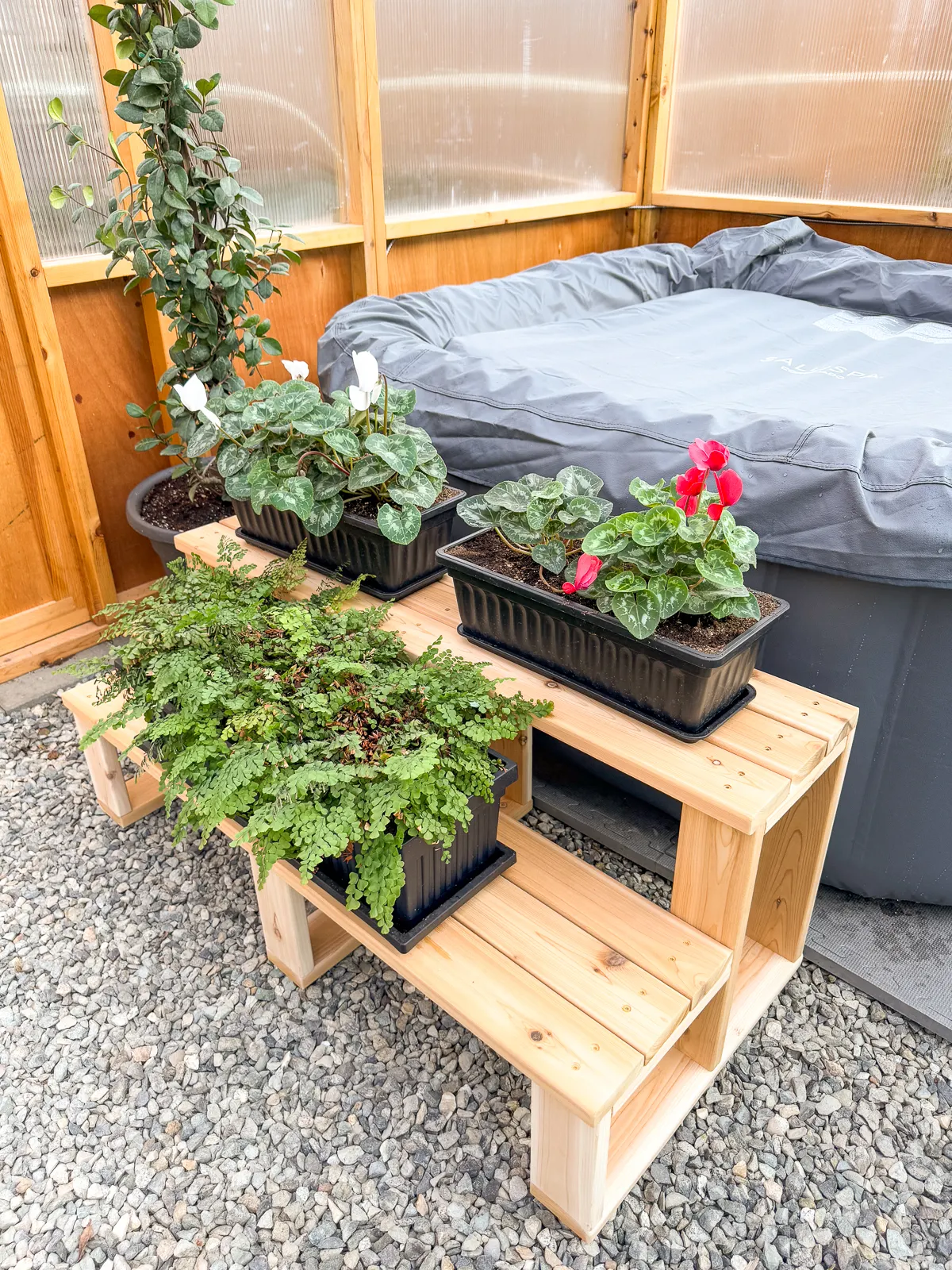 DIY hot tub stairs that double as a plant stand when the hot tub is not in use