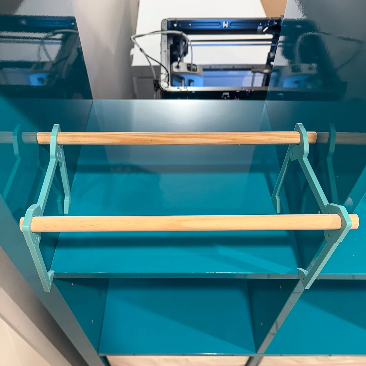 inserting dowels into filament storage rack in IKEA Kallax shelving unit