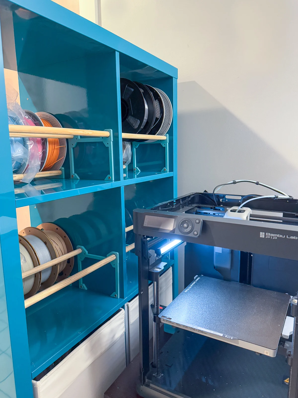 partially empty filament storage racks on back of IKEA Kallax